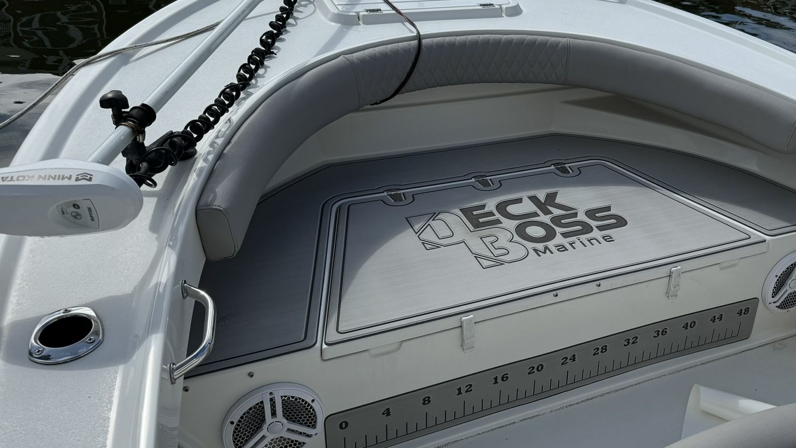 Custom gray EVA foam boat deck with the Deck Boss Marine logo cut into the hatch