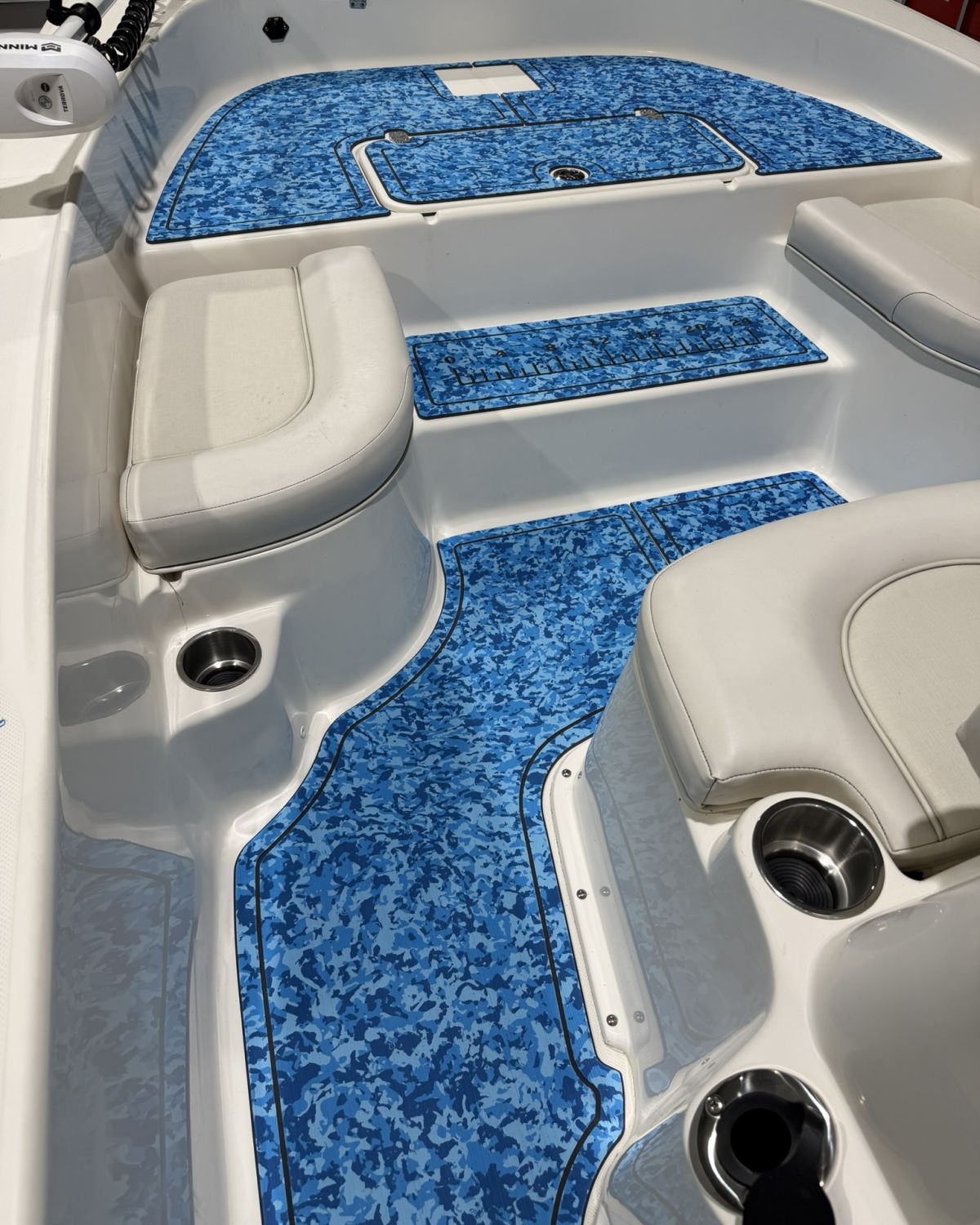 Side view of a Sundance bay boat walkway covered in custom-fit blue camo foam decking