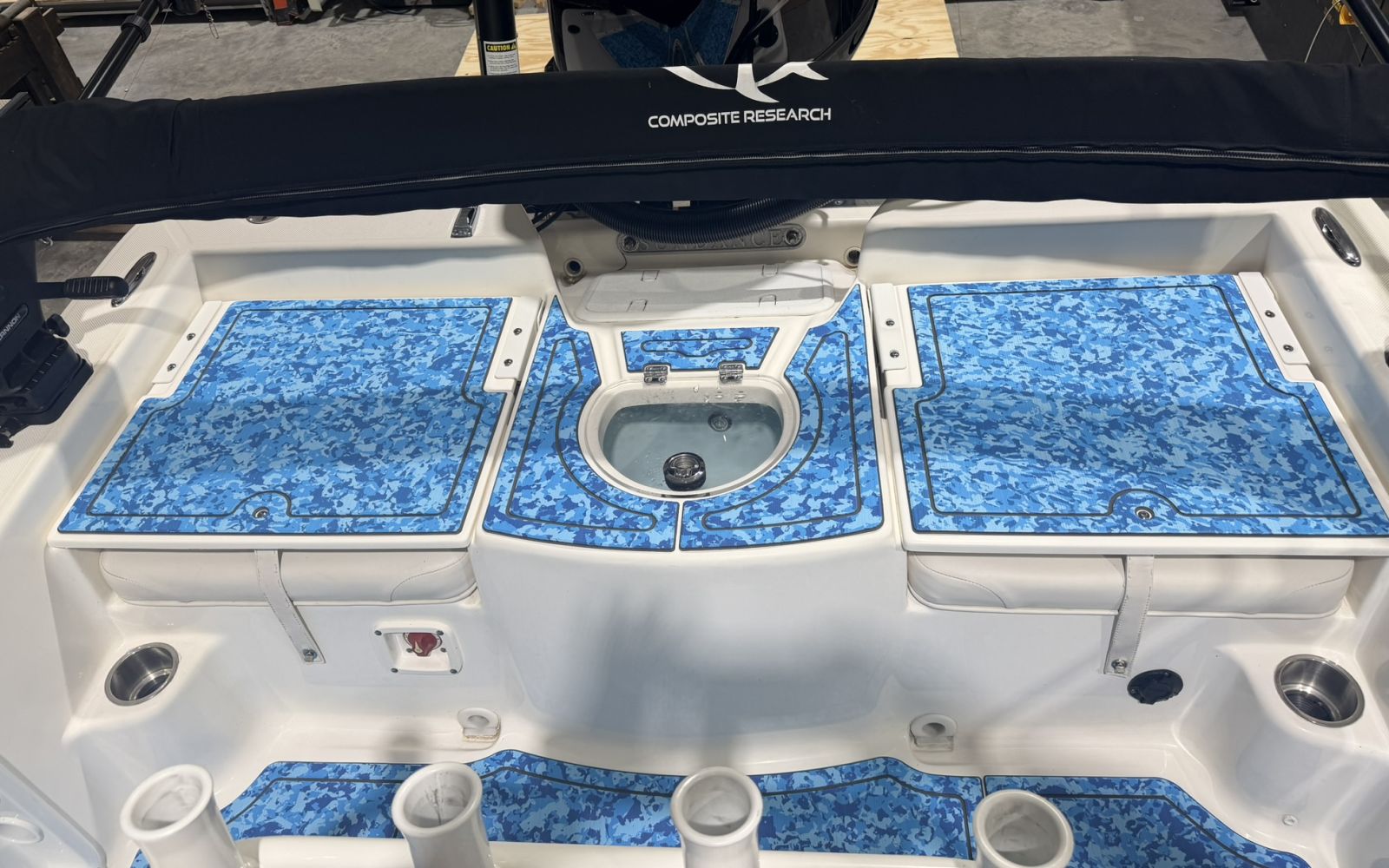 Stern hatches and livewell of a Sundance bay boat with blue camo EVA foam pads
